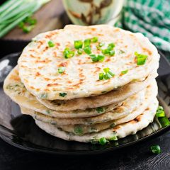 Traditional indian bread. Pita bread with green onions. Onion naan.